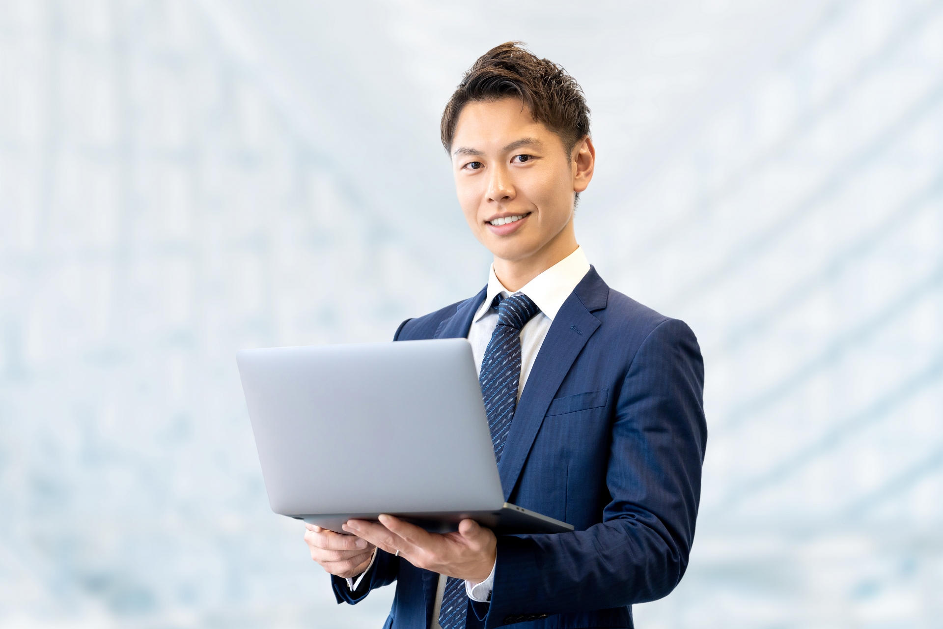 Smiling business professional using a laptop